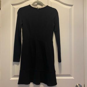 Black dress with white ruffle collar.